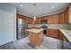 A kitchen boasts granite countertops, stainless steel appliances, central island, and wood cabinetry at 830 Buffington Way, Canton, GA 30115