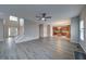 Open-concept living room with high ceilings, modern ceiling fan and new light gray vinyl flooring at 830 Buffington Way, Canton, GA 30115