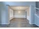 Spacious living room with light gray walls, wainscoting, and new light gray vinyl flooring at 830 Buffington Way, Canton, GA 30115