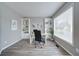 Bright office space with a large window, built-in shelves, and new light gray vinyl floors at 830 Buffington Way, Canton, GA 30115