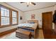 Bedroom featuring wood trim, hardwood floors, a ceiling fan, natural light and neutral walls at 1716 Rogers Sw Ave, Atlanta, GA 30310