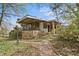 Quaint home exterior featuring stone details, a covered porch, and a brick pathway at 1716 Rogers Sw Ave, Atlanta, GA 30310