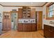 Eat-in kitchen showcasing hardwood floors, wooden cabinets, and natural light at 1716 Rogers Sw Ave, Atlanta, GA 30310