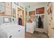 Charming laundry room features pale blue walls covered in art and decor, with modern washer and dryer at 1716 Rogers Sw Ave, Atlanta, GA 30310