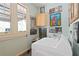 Well-lit laundry area with a modern washer, sink, and plenty of wall decor at 1716 Rogers Sw Ave, Atlanta, GA 30310