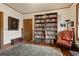 Cozy reading room featuring floor-to-ceiling bookshelves and a tufted leather armchair at 1716 Rogers Sw Ave, Atlanta, GA 30310