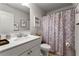 Clean bathroom featuring a stylish vanity, ample lighting, and decorative shower curtain at 3218 Garden Hill Ln, Douglasville, GA 30135