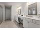 Elegant bathroom with dual sinks, white cabinetry, and tiled floors at 3218 Garden Hill Ln, Douglasville, GA 30135