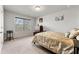 Bright bedroom with a large window, neutral decor, and comfortable carpeting at 3218 Garden Hill Ln, Douglasville, GA 30135