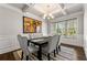 Elegant dining room featuring a stylish table with upholstered chairs, a coffered ceiling, and abundant natural light at 3218 Garden Hill Ln, Douglasville, GA 30135
