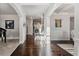 Elegant foyer boasting hardwood floors, white paneled walls, and an open layout with a grand piano nearby at 3218 Garden Hill Ln, Douglasville, GA 30135
