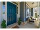 Welcoming front porch featuring comfortable chairs, natural light, and a vibrant blue door, perfect for relaxation at 3218 Garden Hill Ln, Douglasville, GA 30135