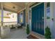Inviting front porch featuring a cozy seating area and a stylish blue front door, enhancing curb appeal at 3218 Garden Hill Ln, Douglasville, GA 30135
