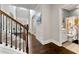 Welcoming hallway with hardwood floors, staircase and access to powder room at 3218 Garden Hill Ln, Douglasville, GA 30135