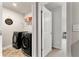 Well-lit laundry room featuring modern black front-load machines and convenient shelving at 3218 Garden Hill Ln, Douglasville, GA 30135
