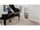 Elegant living room featuring a grand piano and open access to the dining room, bathed in natural light at 3218 Garden Hill Ln, Douglasville, GA 30135