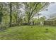 View of a large backyard surrounded by trees and fencing at 3540 Victoria St, Atlanta, GA 30337