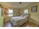Bedroom features a queen bed, wood floors, and two windows at 3540 Victoria St, Atlanta, GA 30337