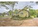 Exterior shot shows a tan home with a gravel driveway at 3540 Victoria St, Atlanta, GA 30337