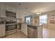 Functional kitchen with stainless steel appliances, granite counters and direct view of the dining and living spaces at 3540 Victoria St, Atlanta, GA 30337