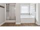 Bright bathroom with a soaking tub, a separate glass-enclosed shower, and contemporary finishes at 406 Dunaway Ct, Grayson, GA 30017