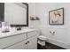 Elegant bathroom featuring a modern vanity, black fixtures, and decorative wall accents at 406 Dunaway Ct, Grayson, GA 30017