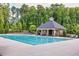 Large community pool with lounge chairs and a covered pavilion, perfect for summer relaxation at 406 Dunaway Ct, Grayson, GA 30017