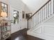 Welcoming entryway featuring a staircase with wood railing, a decorative front door, and elegant wall paneling at 406 Dunaway Ct, Grayson, GA 30017