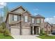A two-story home with a stone and siding exterior, two-car garage, and landscaped front yard at 406 Dunaway Ct, Grayson, GA 30017