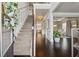 Inviting foyer with hardwood floors, staircase, and views into the dining room and kitchen at 406 Dunaway Ct, Grayson, GA 30017