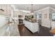 Modern kitchen with white cabinets, granite countertops, stainless steel appliances, and a center island at 406 Dunaway Ct, Grayson, GA 30017