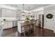 Bright kitchen featuring stainless steel appliances, white cabinets, a central island, and hardwood floors at 406 Dunaway Ct, Grayson, GA 30017
