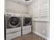 Bright laundry room featuring a side-by-side washer and dryer and a convenient wall-mounted drying rack at 406 Dunaway Ct, Grayson, GA 30017