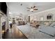 Open-concept living area with fireplace, gray sectional sofa, and seamless access to the kitchen and dining space at 406 Dunaway Ct, Grayson, GA 30017