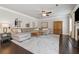 Cozy living room featuring a fireplace, large windows, and a comfortable sectional sofa at 406 Dunaway Ct, Grayson, GA 30017