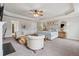 Spacious main bedroom suite with sitting area, trey ceilings, plush carpet, and natural light at 406 Dunaway Ct, Grayson, GA 30017