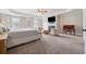 Main bedroom suite with sitting area, trey ceilings, fireplace, plush carpet, and natural light at 406 Dunaway Ct, Grayson, GA 30017
