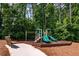 Community playground area with slides, a bench, and climbing equipment, surrounded by lush trees at 406 Dunaway Ct, Grayson, GA 30017