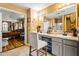 A spacious bathroom with double vanity, a seated makeup counter, and an open doorway to the bedroom at 859 Pownal Ln, Hampton, GA 30228