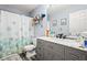 Modern bathroom featuring gray vanity, gray walls and a patterned shower curtain at 859 Pownal Ln, Hampton, GA 30228