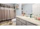 Bathroom with gray vanity and shower and bathtub combination with patterned curtain at 859 Pownal Ln, Hampton, GA 30228