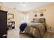 Cozy bedroom featuring light colored walls, wood floors, many windows and a comfortable bed at 859 Pownal Ln, Hampton, GA 30228