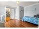Bright bedroom featuring wood floors, blue accents, and an adjacent living area at 859 Pownal Ln, Hampton, GA 30228