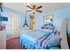 Blue bedroom with a ceiling fan and adjacent sitting area. Carpeted and cozy at 859 Pownal Ln, Hampton, GA 30228