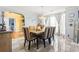 Elegant dining room with stylish chairs, modern chandelier, and bright window at 859 Pownal Ln, Hampton, GA 30228
