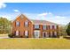 A well-maintained brick home with red shutters and a manicured front lawn at 859 Pownal Ln, Hampton, GA 30228