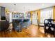 Well-lit kitchen featuring gray cabinets, a breakfast bar, and hardwood floors at 859 Pownal Ln, Hampton, GA 30228