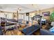 Spacious primary bedroom featuring a cozy sitting area, gym equipment, and hardwood floors at 859 Pownal Ln, Hampton, GA 30228