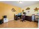 Home office with hardwood floors, large desk, printer, mini fridge and decorative wall art at 859 Pownal Ln, Hampton, GA 30228