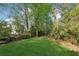 Lush green backyard with mature trees offering shade and privacy at 2434 Skyland Ne Trl, Brookhaven, GA 30319